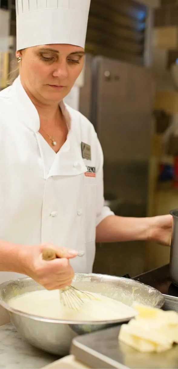 Harmons baker whisking batter in the bakery kitchen