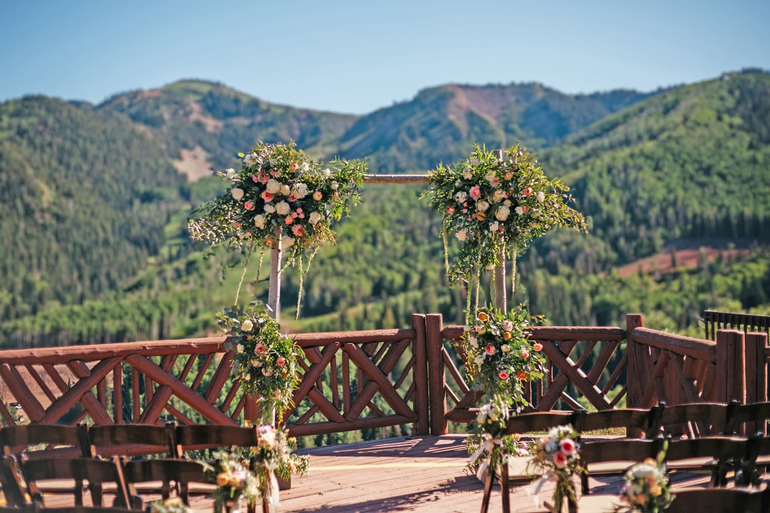 Wedding floral arrangements set against a mountain backdrop