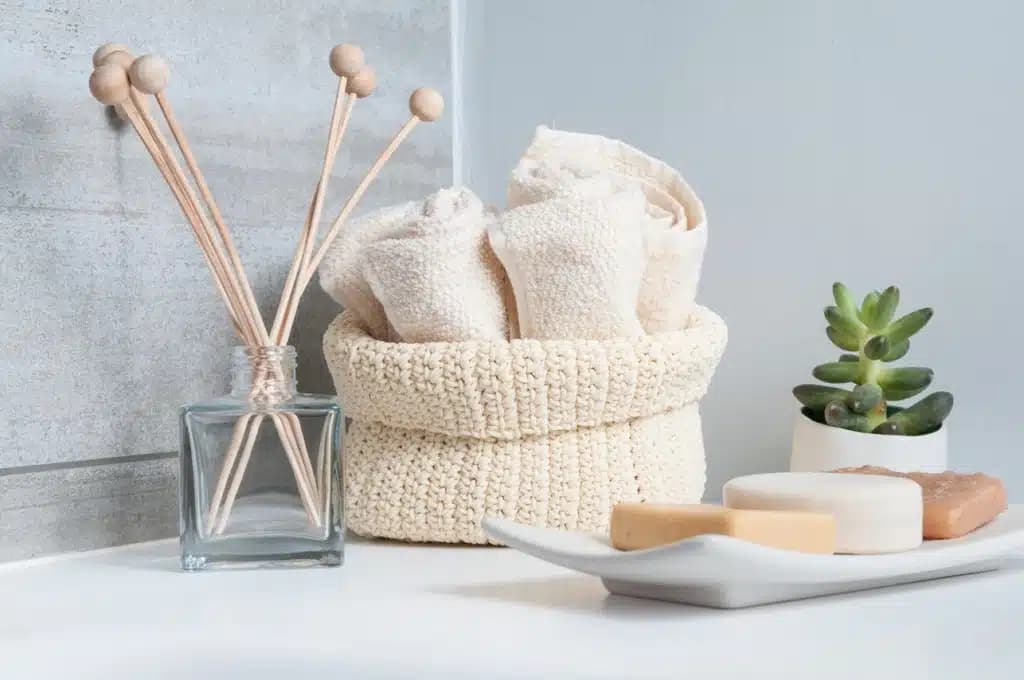 Spa-style bathroom with reed diffuser, rolled towels and soap