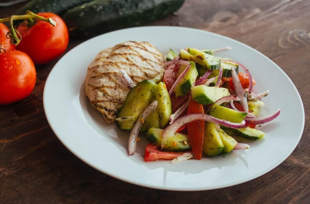 Fresh cucumber tomato salad with grilled chicken