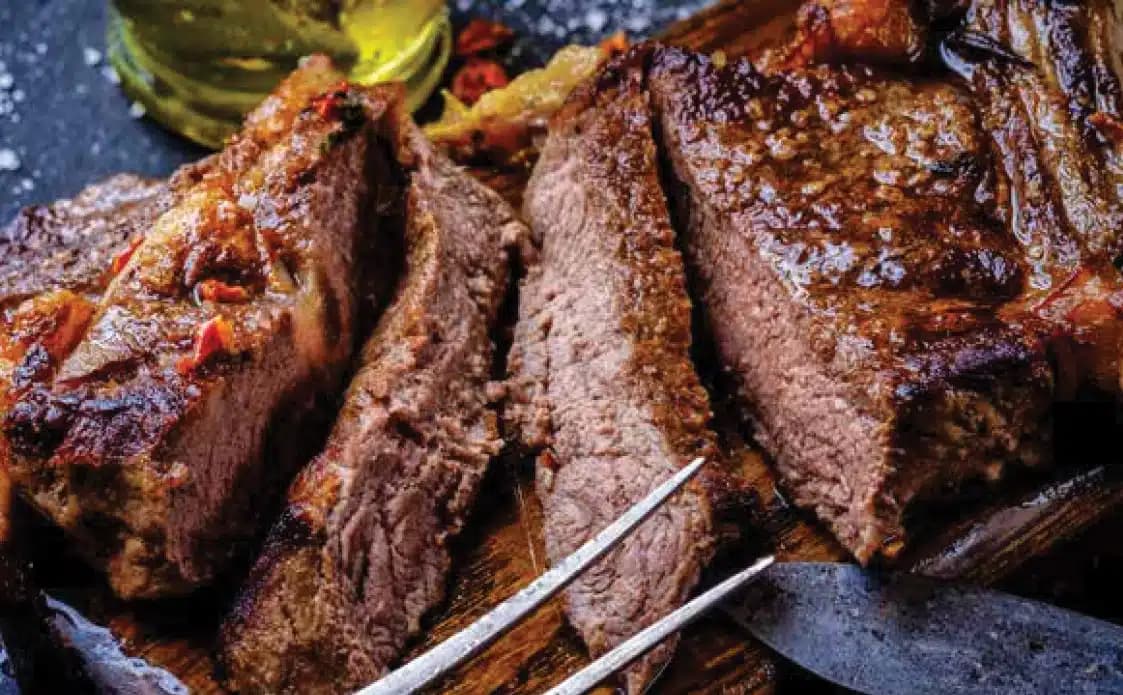 Sliced grilled steak on a skewer