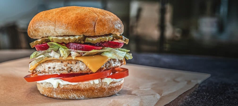 Grilled chicken burger with pickled beets and tomatoes
