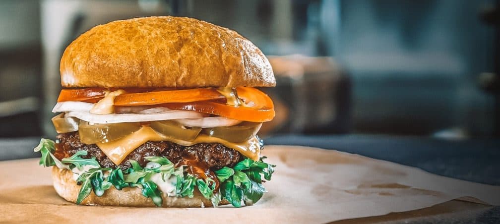 Beef burger with American cheese and arugula